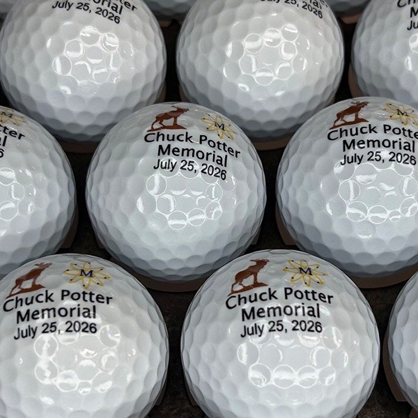 Personalized memorial golf balls printed with a name and date