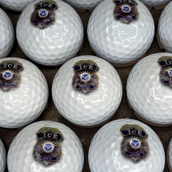 Logo golf balls printed with a detailed purple and gold emblem