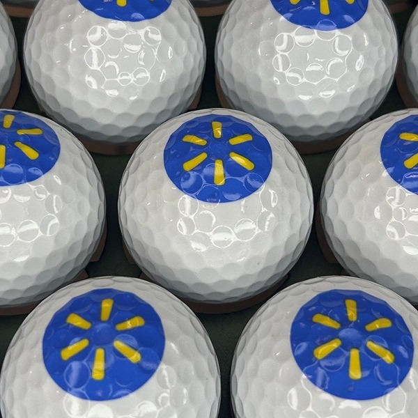Personalized golf balls featuring a blue and yellow corporate logo