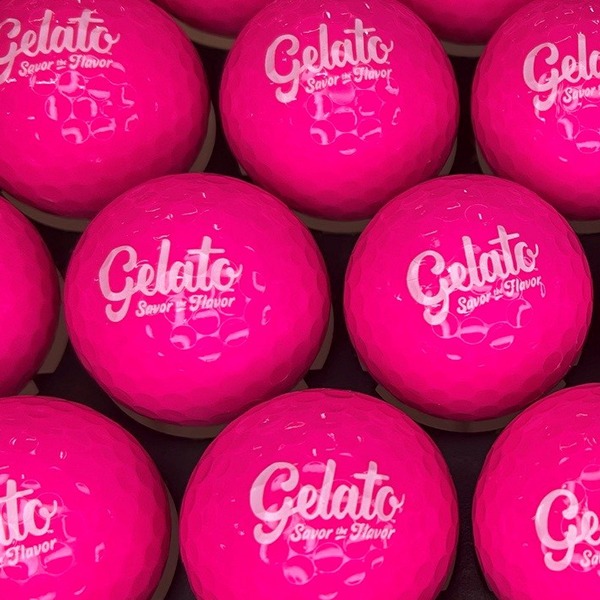 Hot pink personalized golf balls printed with a white logo