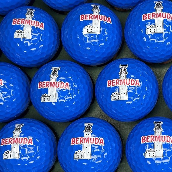 Blue custom golf balls featuring a colorful destination-themed logo
