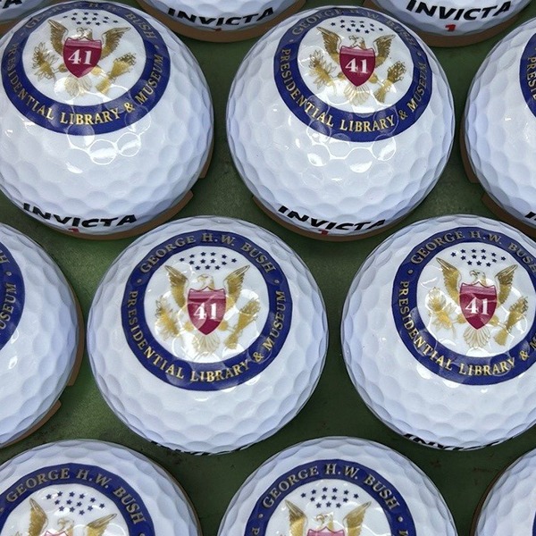 Custom logo golf balls featuring a patriotic circular emblem