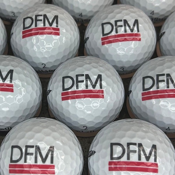 Custom logo golf balls featuring black and red corporate branding