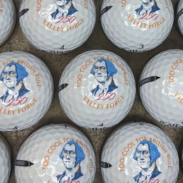 Personalized golf balls featuring a colorful illustrated portrait design