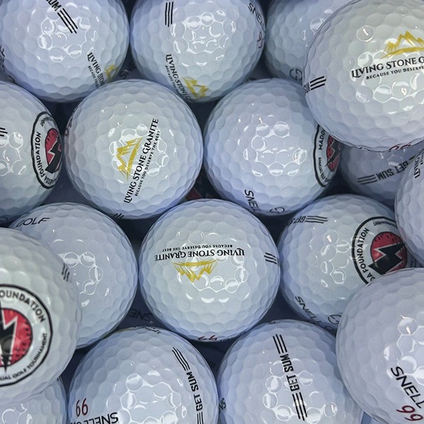 Custom logo golf balls featuring assorted tournament and event designs