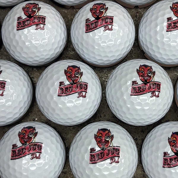 Logo golf balls featuring a custom red mascot design