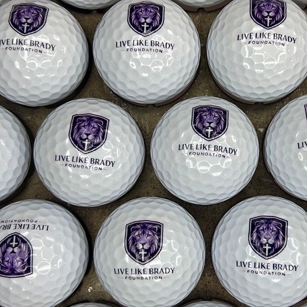 Personalized golf balls printed with a purple commemorative design