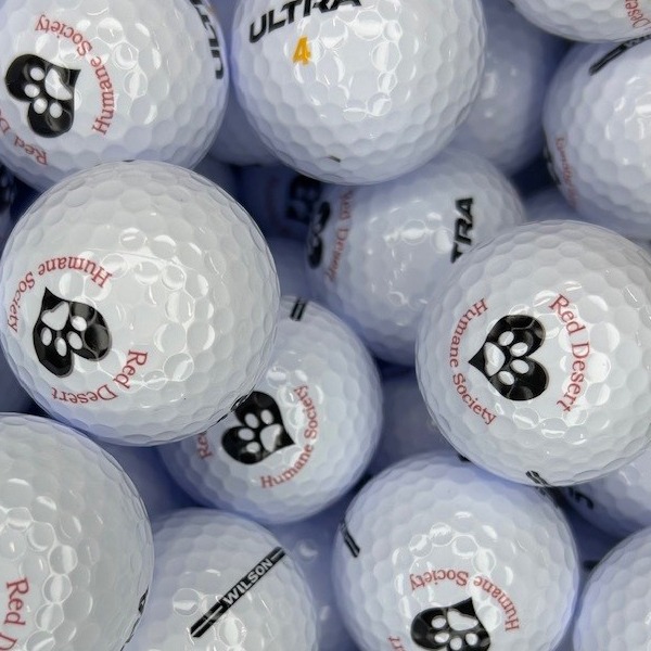 Personalized golf balls featuring a custom paw print design