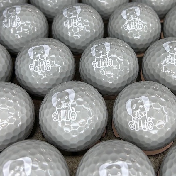 Gray personalized golf balls featuring a white dog design