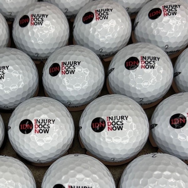 Custom golf balls featuring black and red company logo printing