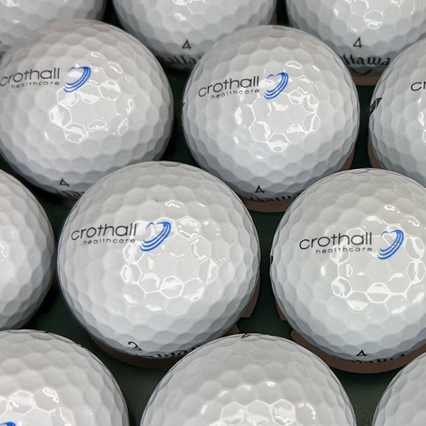 Custom golf balls featuring printed business logos