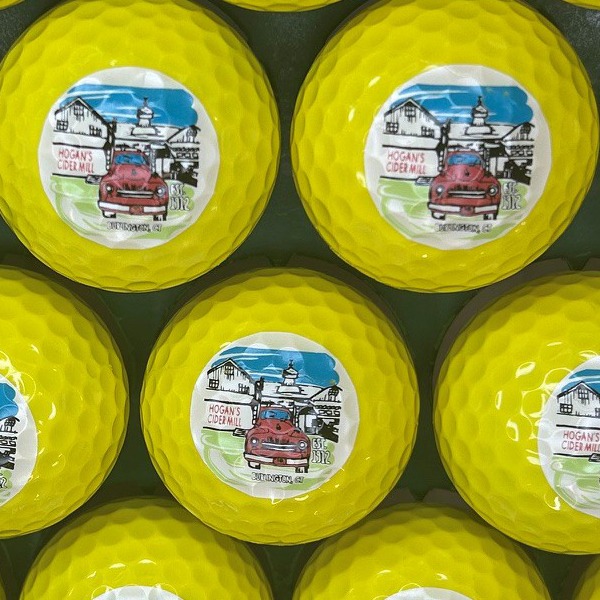 Yellow custom golf balls printed with a full-color illustrated design