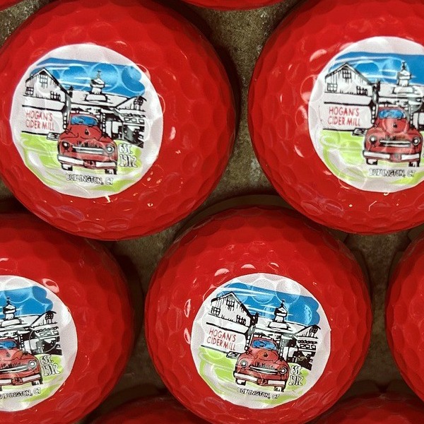 Red custom golf balls printed with a full-color illustrated design
