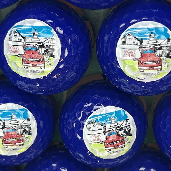 Dark blue custom golf balls printed with a full-color illustrated design