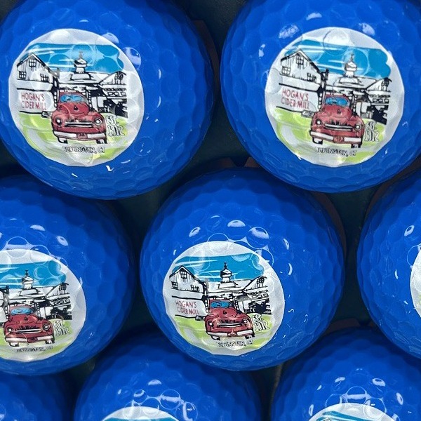 Medium blue custom golf balls featuring a full-color illustrated design