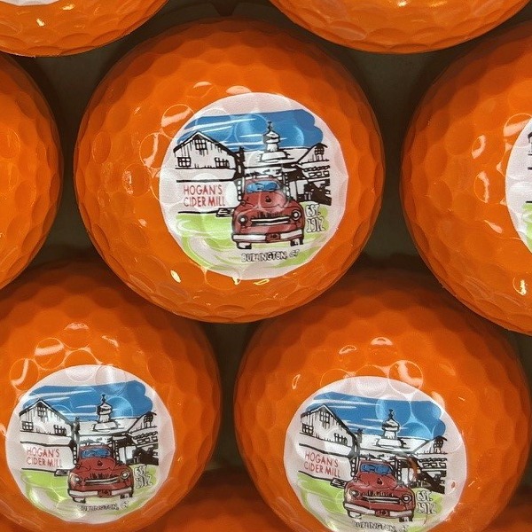 Orange custom golf balls printed with a full-color illustrated design