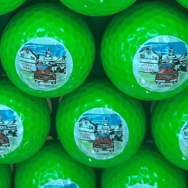 Green personalized golf balls featuring a full-color illustrated design