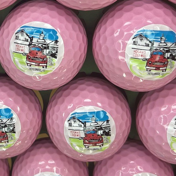 Light pink personalized golf balls printed with a full-color illustrated design