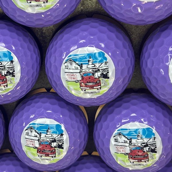 Light purple custom golf balls featuring a full-color illustrated design