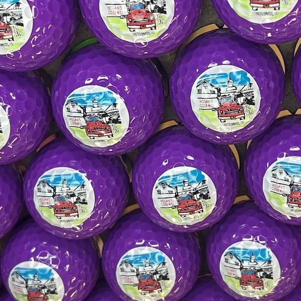 Purple custom golf balls printed with a full-color illustrated design