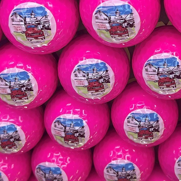 Hot pink personalized golf balls featuring a full-color illustrated design