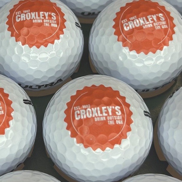 Custom logo golf balls featuring an orange circular design