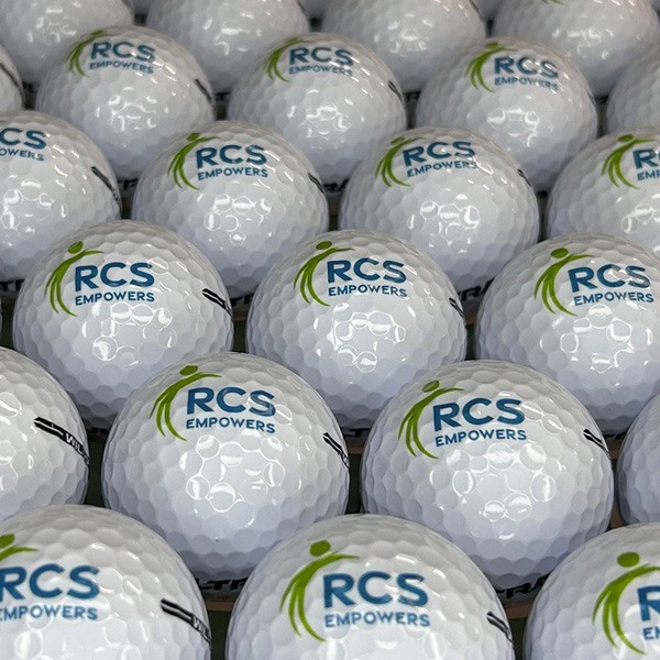 Logo imprinted on golf ball in green and blue