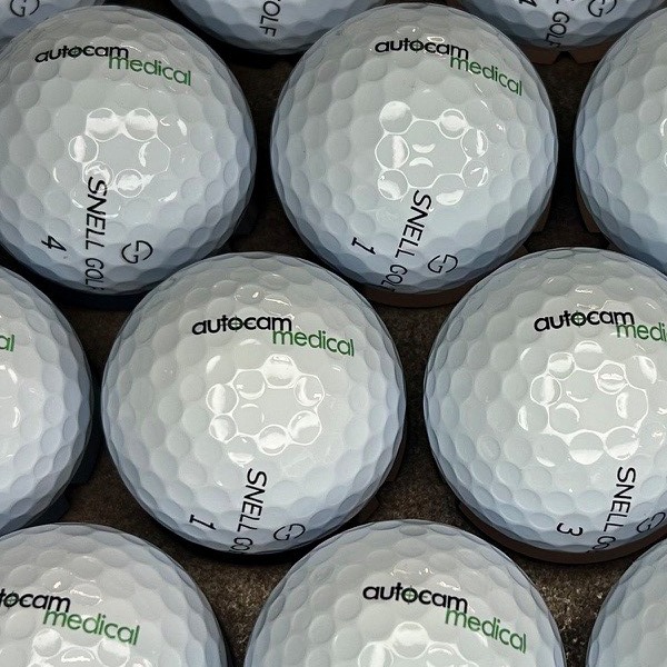Snell custom golf balls printed with green company branding