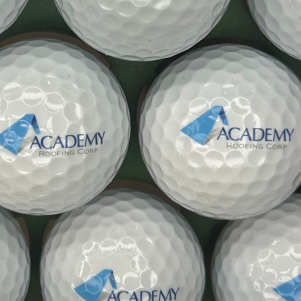 Logo golf balls featuring a blue and gray corporate design