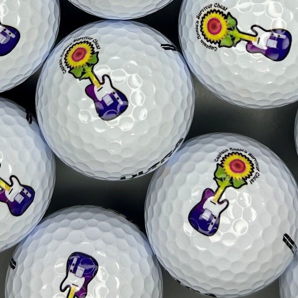 Personalized golf balls featuring a colorful guitar design