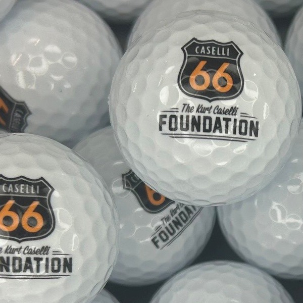 White logo golf balls printed with a highway shield foundation logo