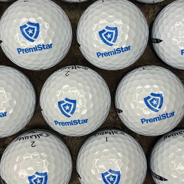 White custom golf balls printed with a blue shield logo