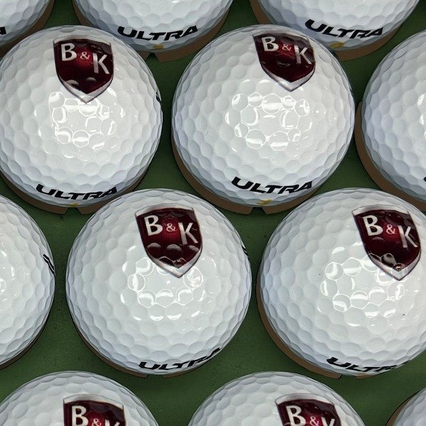 Wilson Ultra golf balls printed with a maroon shield logo