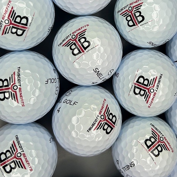 Snell golf balls printed with a red and black company logo
