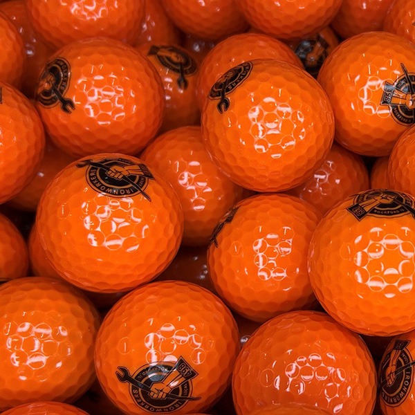 Orange custom golf balls printed with a black company logo