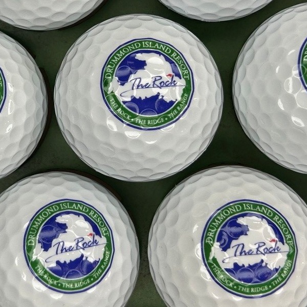 White custom golf balls printed with a full-color island resort logo