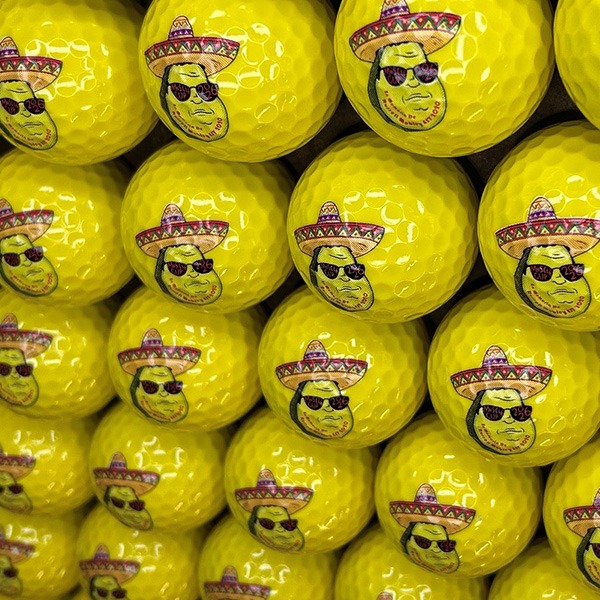 Yellow custom golf balls featuring a colorful printed logo