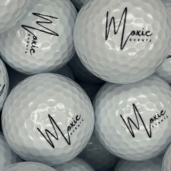 White personalized golf balls printed with a black script logo