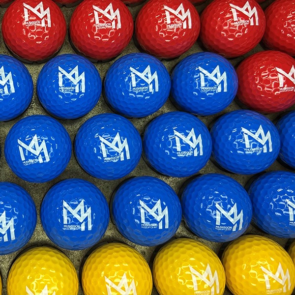 Red, blue and yellow custom golf balls printed with a white crown logo