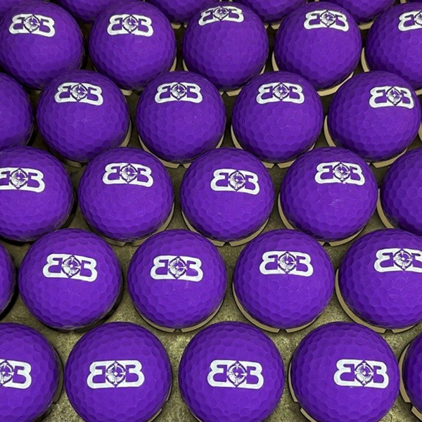 Purple custom bulk golf balls printed with a white logo