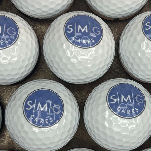 White branded golf balls printed with a blue circular logo