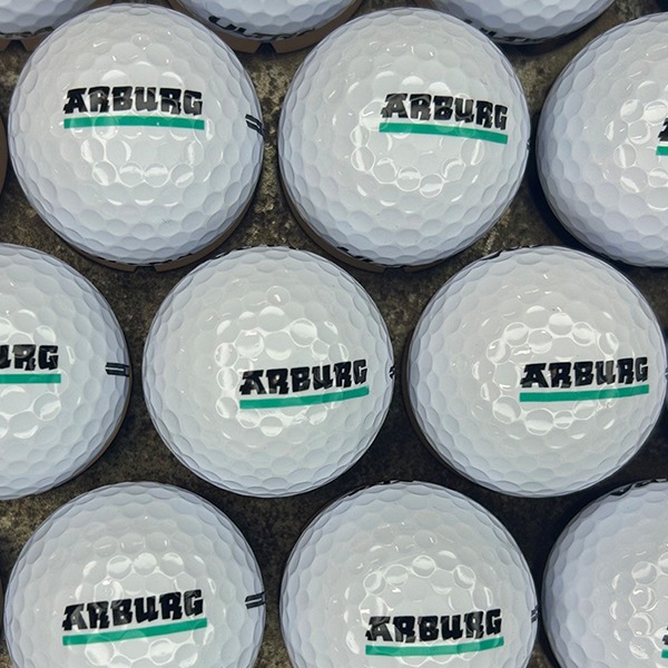 White custom golf balls printed with a black and teal company logo