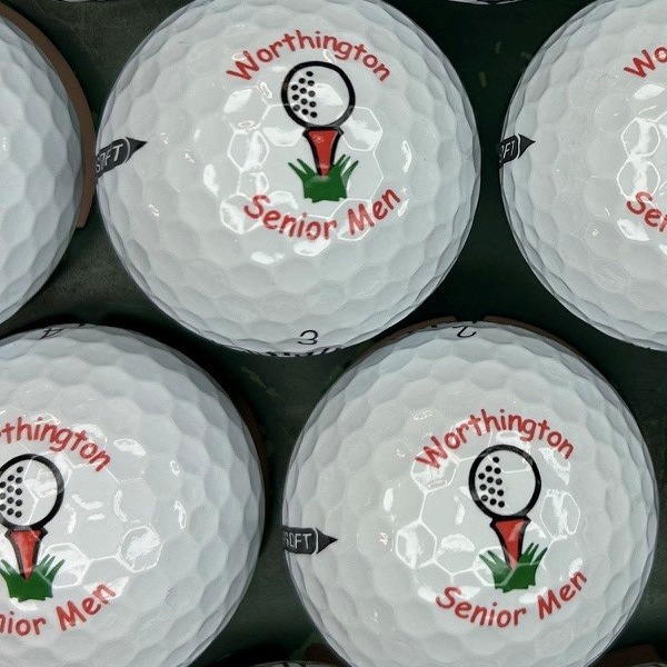 White personalized golf balls printed with a golf ball and tee logo for a senior league
