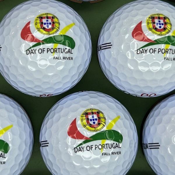 White custom golf balls printed with a full-color festival logo