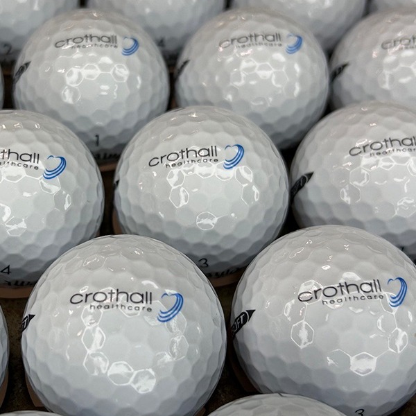 Logo golf balls featuring a custom blue and black design