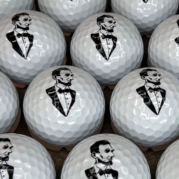 Logo golf balls featuring a custom black illustrated design of Abe Licoln