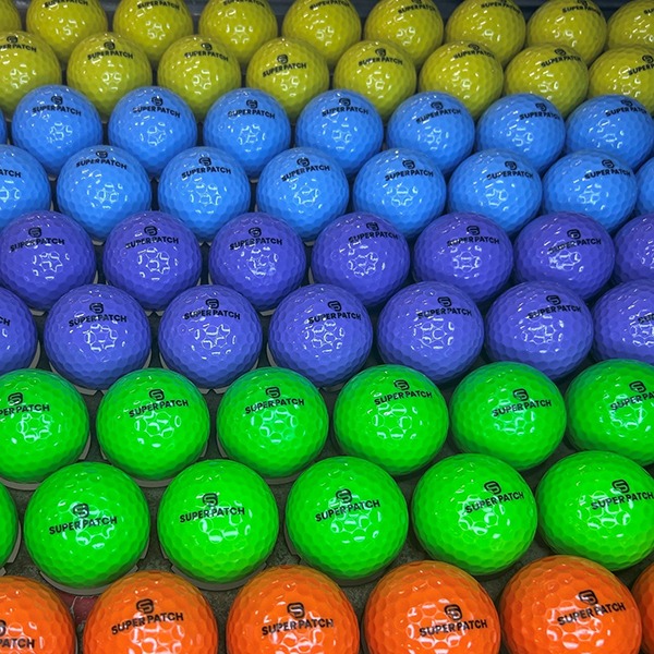 Personalized colored golf balls in blue, purple, green, yellow and orange
