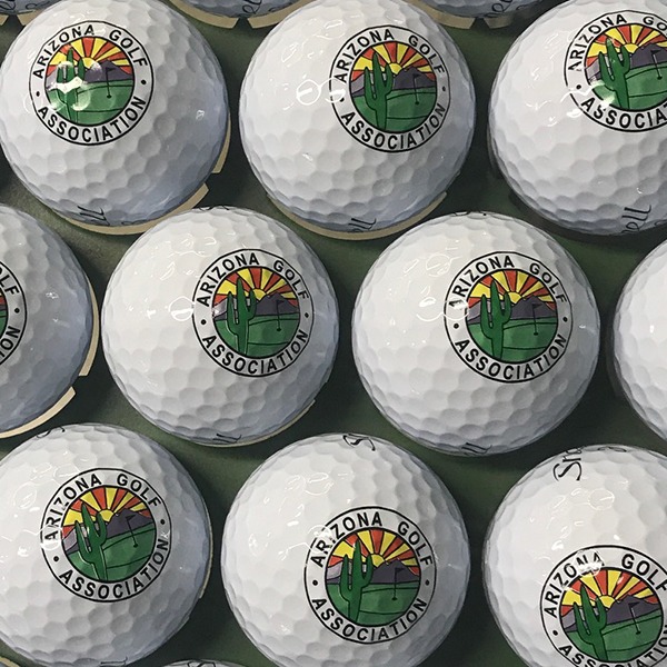 Custom logo golf balls featuring a colorful circular design