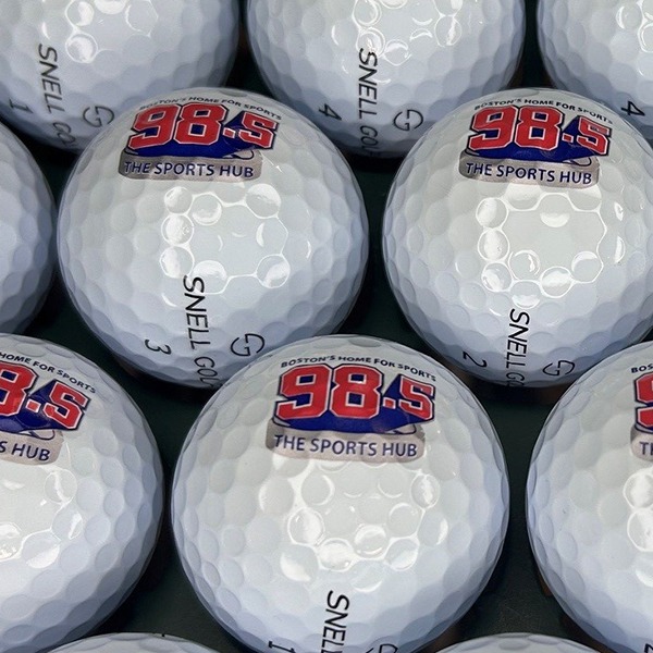Logo golf balls featuring custom red and blue radio broadcasting branding