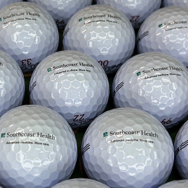 Custom golf balls printed with green and gray company branding